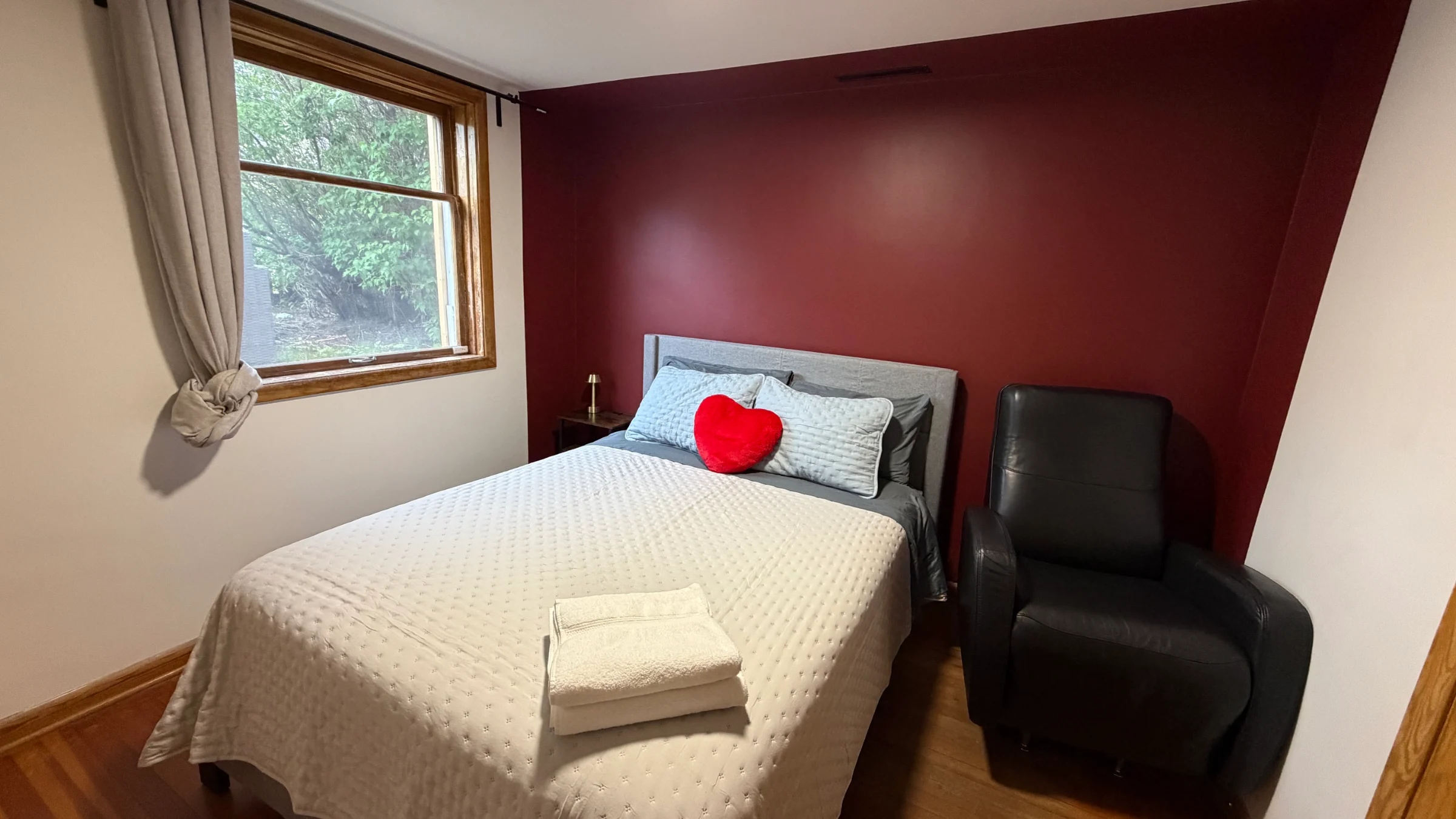 Cabernet Sauvignon Retreat bedroom with deep burgundy velvet headboard and brass lamps