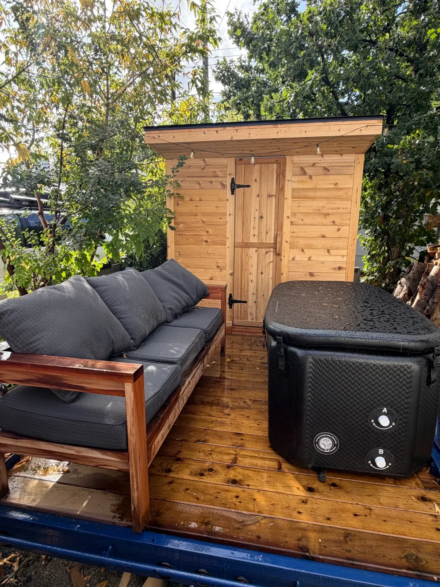 The cedar sauna, covered cold plunge and cushioned lounge at Merlot House